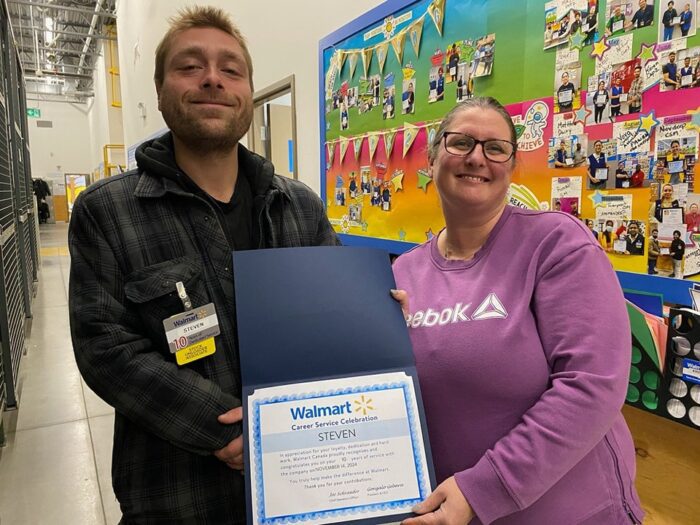 Steven and his Manager at Walmart presenting 10 yr certificate.